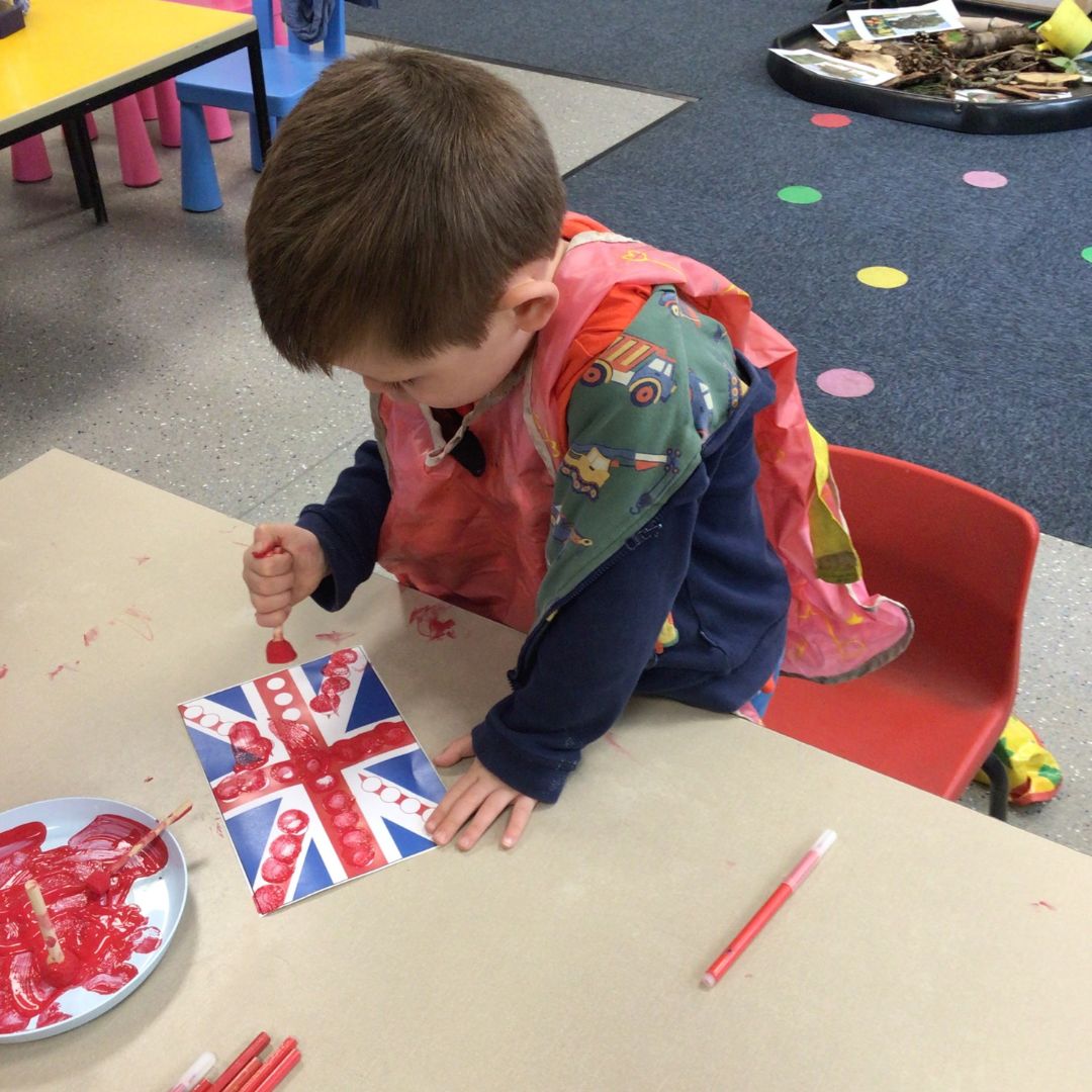 nursery child painting a union flag for VE day